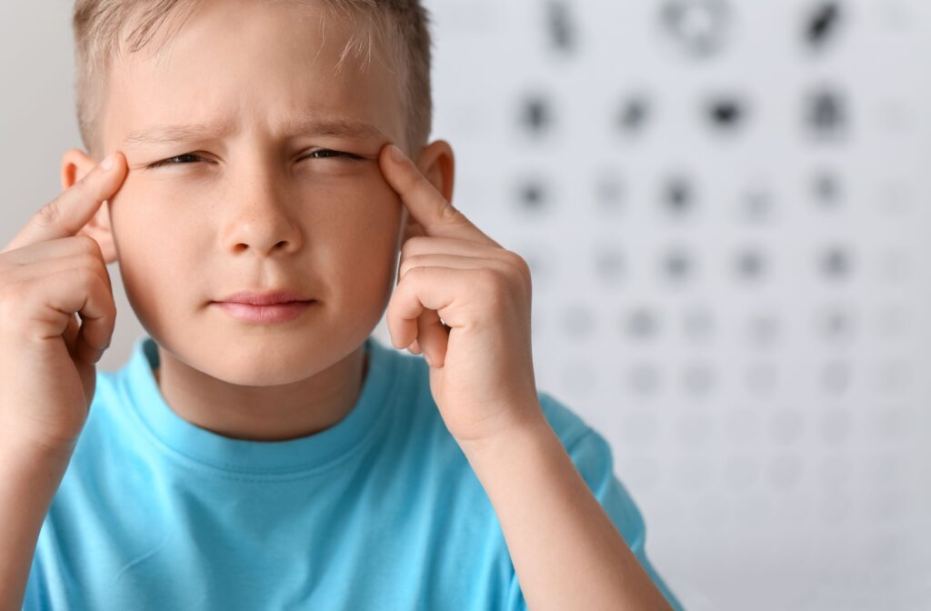 A child squints so they can see clearly.