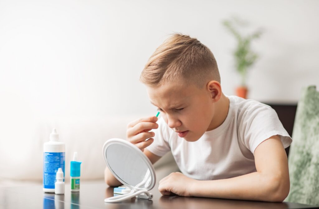 a child uses a contact lens plunger to remove contact lenses from their eye