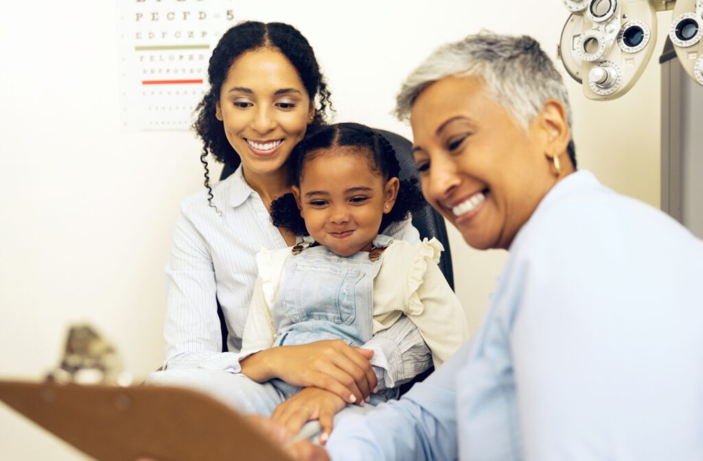 A child smiling and being entertained while visiting the optometrist