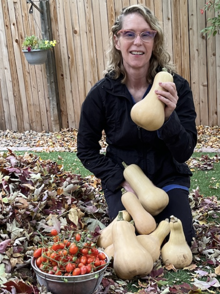 Dr. Metzger holding a squash from her garden